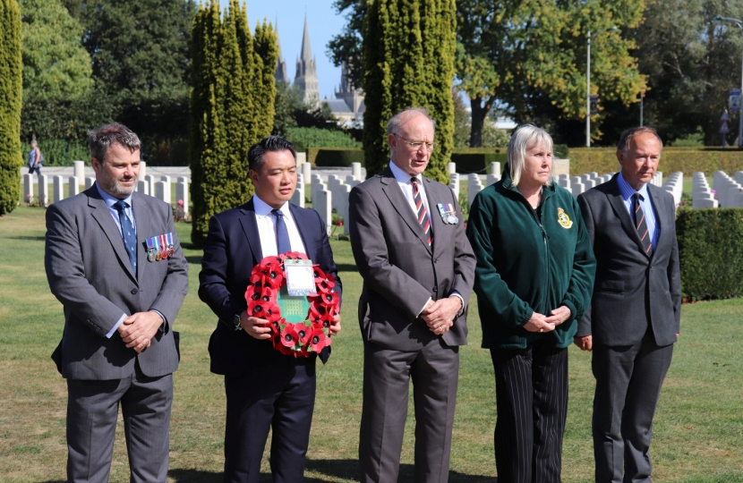 Alan Mak MP and local veterans paying their respects at the Bayeux War Cemetery in 2019