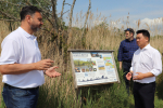 Photo: Alan Mak MP inspects the Langstone Mill Pond and surrounding area with Lyall Cairns, Head of Coastal Partners.