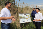 Photo: Alan Mak MP inspects the Langstone Mill Pond and surrounding area with Lyall Cairns, Head of Coastal Partners.
