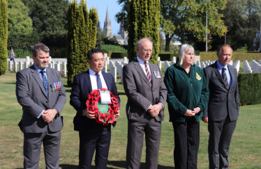 Alan Mak MP and local veterans paying their respects at the Bayeux War Cemetery in 2019 